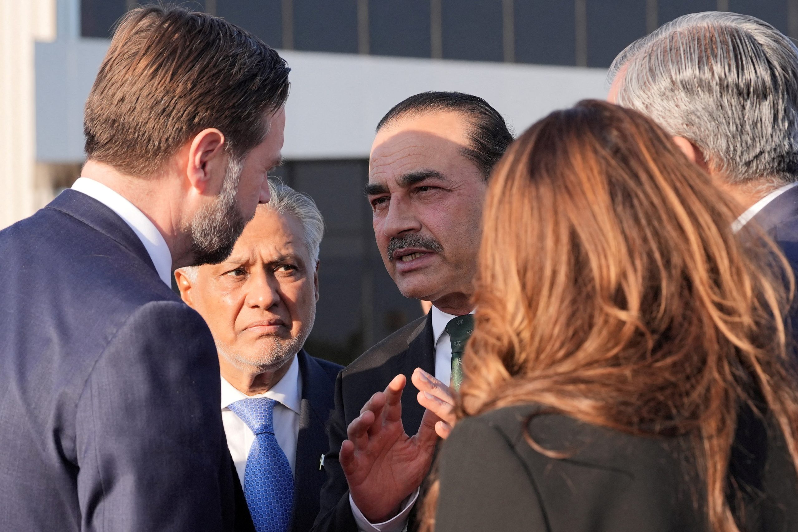 FILE PHOTO: Vice President JD Vance, left, talks to Pakistan's Chief of Defence Forces and Chief of Army Staff Field Marshall Asim Munir, right, and Pakistani Deputy Prime Minister and Foreign Minister Mohammad Ishaq Dar, center, before boarding Air Force Two after attending talks on Iran in Islamabad, Pakistan, Sunday, April 12, 2026.     Jacquelyn Martin/Pool via REUTERS/File Photo